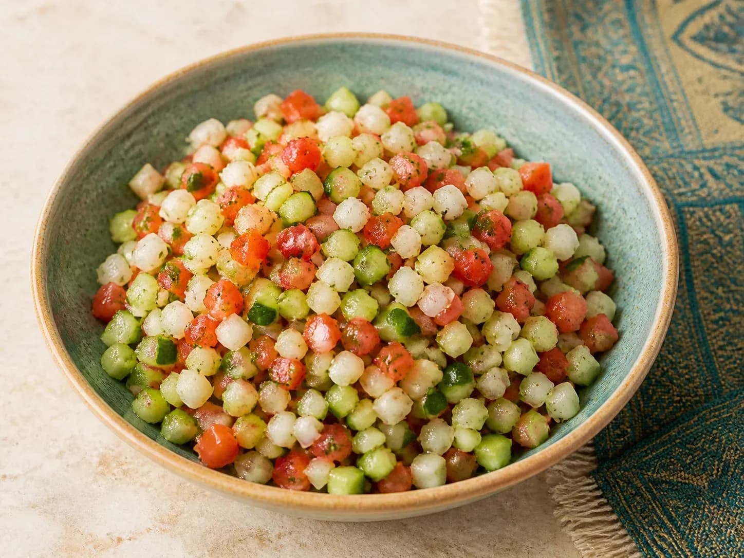 Finely diced Salad Shirazi with Persian cucumber, tomato, onion, and dried mint